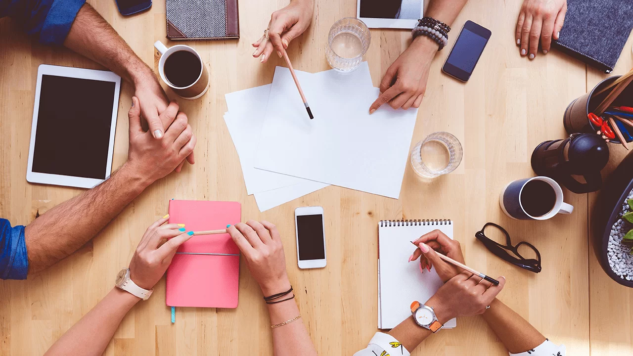 People at a table planning an advertising job